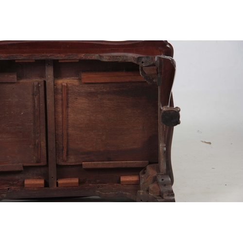 283 - A 19TH CENTURY CHINESE HARDWOOD LOW OCCASIONAL TABLE with panelled top and shaped scroll carved base... 