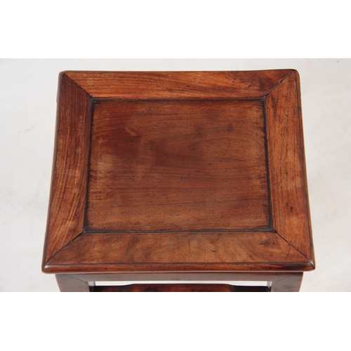 285 - A 19TH CENTURY CHINESE HARDWOOD JARDINIERE STAND with panelled top and square legs joined by shaped ... 