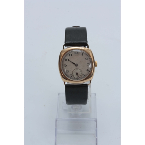 363 - A 9ct GOLD VINTAGE WRIST WATCH having a tank shape case enclosing a silvered dial with Arabic numera... 