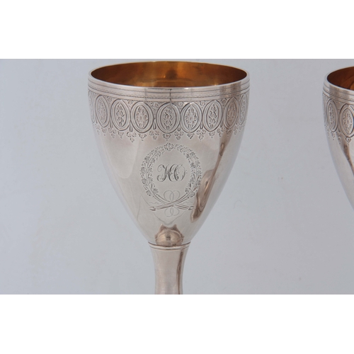 372 - A FINE PAIR OF LATE 18th CENTURY SILVER AND GILT GOBLETS having bright cut foliate engraved decorati... 