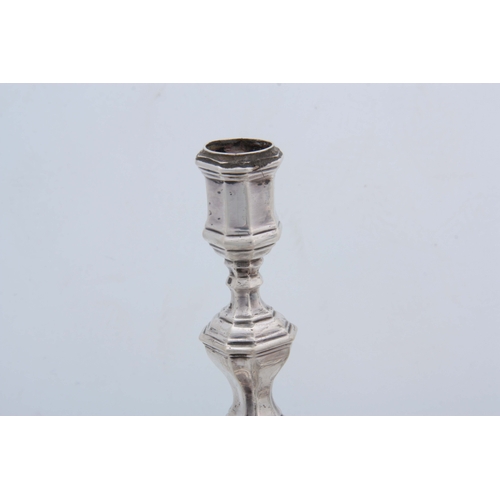 382 - A SET OF FOUR CONTINENTAL CAST SILVER CANDLE STICKS having moulded square bases, octagonal stems, ap... 