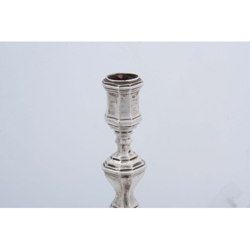 382 - A SET OF FOUR CONTINENTAL CAST SILVER CANDLE STICKS having moulded square bases, octagonal stems, ap... 