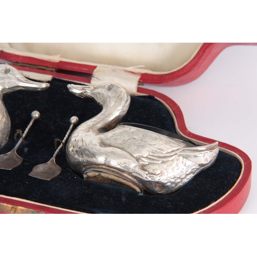 383 - A CASED PAIR OF FIGURAL SILVER SALTS MODELLED AS DUCKS WITH SHOVEL SHAPED SALT SPOONS hallmarked for... 