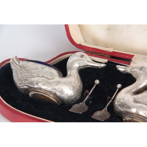 383 - A CASED PAIR OF FIGURAL SILVER SALTS MODELLED AS DUCKS WITH SHOVEL SHAPED SALT SPOONS hallmarked for... 