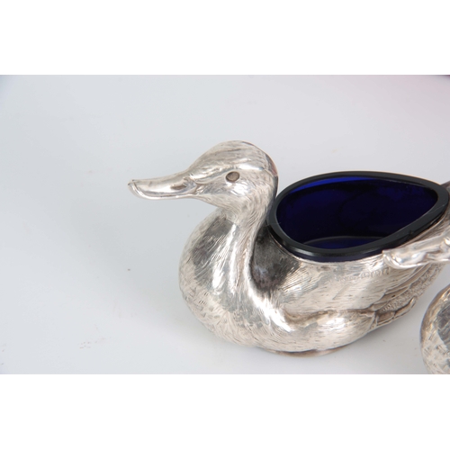 383 - A CASED PAIR OF FIGURAL SILVER SALTS MODELLED AS DUCKS WITH SHOVEL SHAPED SALT SPOONS hallmarked for... 