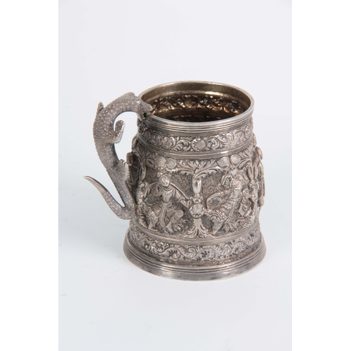 395 - A LATE 19th / EARLY 20th CENTURY INDIAN SILVER TANKARD having high relief decoration of female dance... 