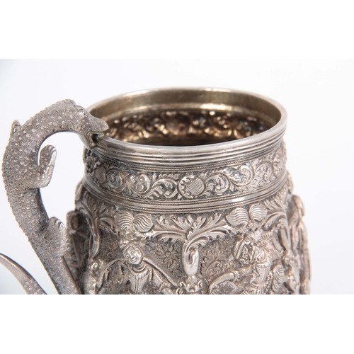 395 - A LATE 19th / EARLY 20th CENTURY INDIAN SILVER TANKARD having high relief decoration of female dance... 