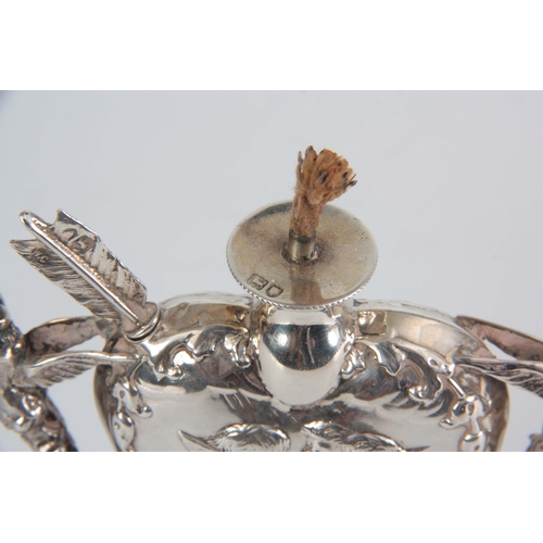 396 - A LATE 19th CENTURY SILVER HEART SHAPED OIL LAMP with relief winged cherub heads and fairy handles o... 