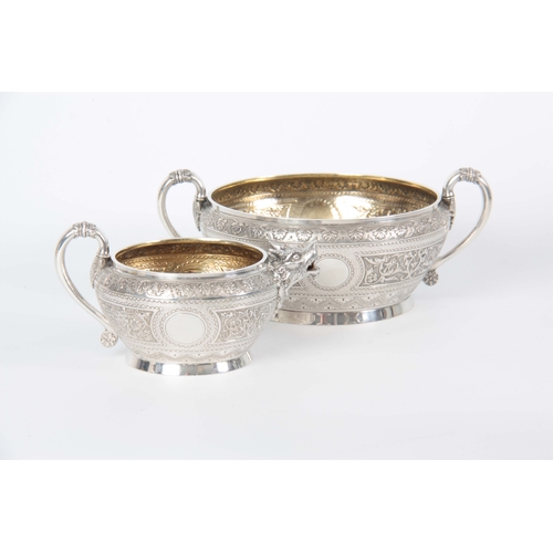 401 - A VICTORIAN SILVER AND GILT CREAM JUG AND SUGAR BOWL  having relief scroll-work panels and fine engr... 