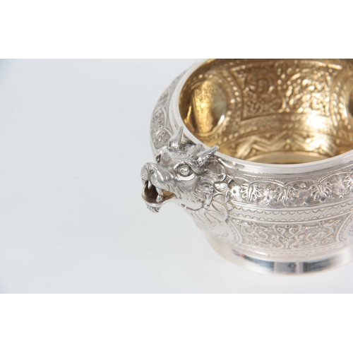 401 - A VICTORIAN SILVER AND GILT CREAM JUG AND SUGAR BOWL  having relief scroll-work panels and fine engr... 