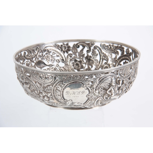 403 - A FINE 18th/19TH CENTURY IRISH SILVER PIERCED AND REPOSE BOWL decorated with a leprechaun, birds and... 