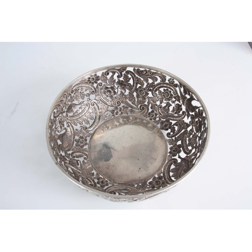 403 - A FINE 18th/19TH CENTURY IRISH SILVER PIERCED AND REPOSE BOWL decorated with a leprechaun, birds and... 