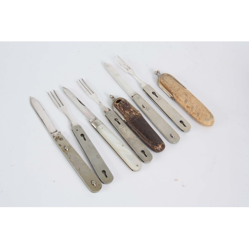 415 - A SELECTION OF THREE EARLY 20TH CENTURY FOLDING FRUIT KNIFE AND FORKS with a split mechanism to sepa... 