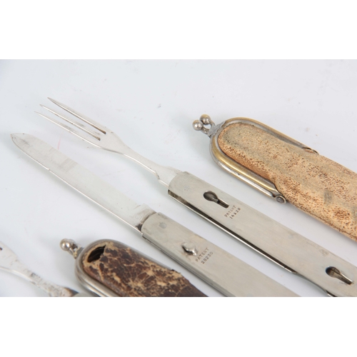 415 - A SELECTION OF THREE EARLY 20TH CENTURY FOLDING FRUIT KNIFE AND FORKS with a split mechanism to sepa... 