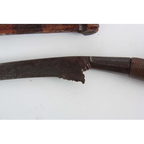 420 - AN 18th/19th CENTURY SUMATRA BADE BADE KNIFE having a 24cm curved steel blade on a carved and pierce... 