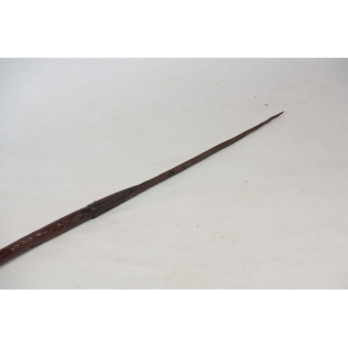 422 - A 19TH CENTURY TRIBAL DOUBLE ENDED SPEAR with carved decoration to the shaft 151cm overall - possibl... 