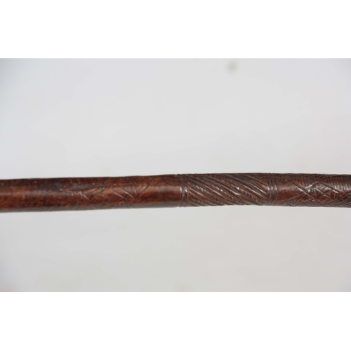 422 - A 19TH CENTURY TRIBAL DOUBLE ENDED SPEAR with carved decoration to the shaft 151cm overall - possibl... 