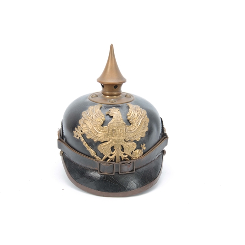 430 - A WW1 GERMAN ' PIKELHAUBE ' LEATHER HELMET with brass spike and gilt brass eagle 21cm high