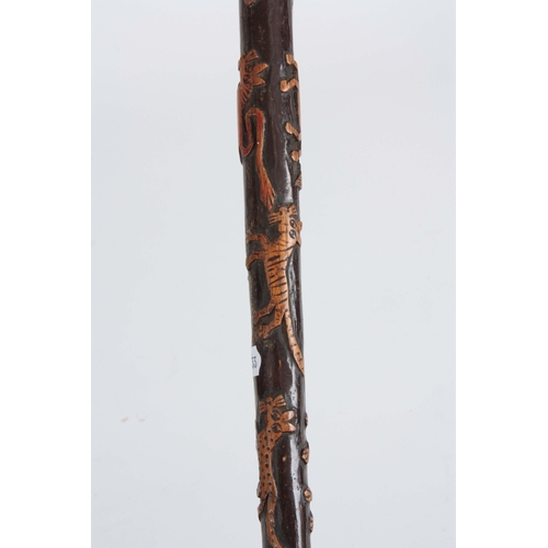 444 - A LATE 19th CENTURY SWORD STICK the fruitwood handle with carved animals head having a brass hinged ... 