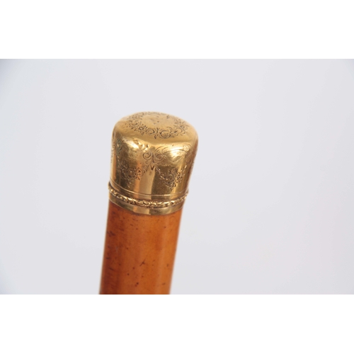 447 - AN EARLY 19th CENTURY 18CT GOLD AND MALACCA WALKING CANE having a floral engraved pommel with eagle ... 