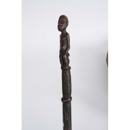 449 - AN AFRICAN CARVED EBONISED WALKING CANE the handle modelled as a seated figure 96cm overall