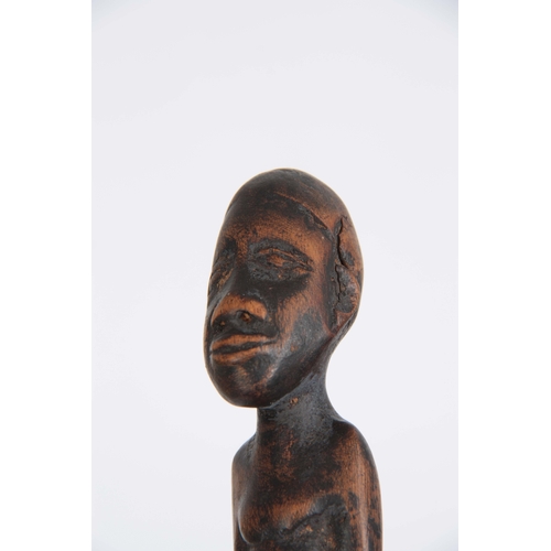 449 - AN AFRICAN CARVED EBONISED WALKING CANE the handle modelled as a seated figure 96cm overall