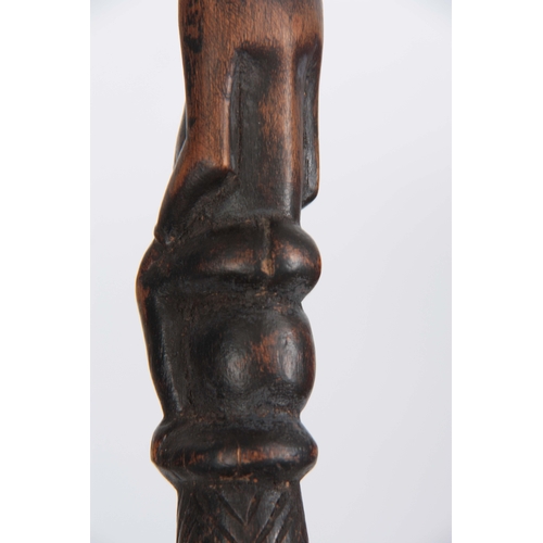 449 - AN AFRICAN CARVED EBONISED WALKING CANE the handle modelled as a seated figure 96cm overall