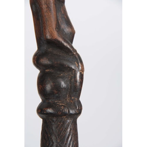 449 - AN AFRICAN CARVED EBONISED WALKING CANE the handle modelled as a seated figure 96cm overall