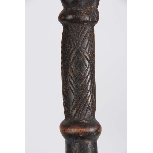 449 - AN AFRICAN CARVED EBONISED WALKING CANE the handle modelled as a seated figure 96cm overall