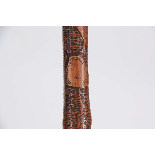 450 - A 19th CENTURY JAPANESE BAMBOO WALKING CANE having a root handle, the stick carved all over with var... 