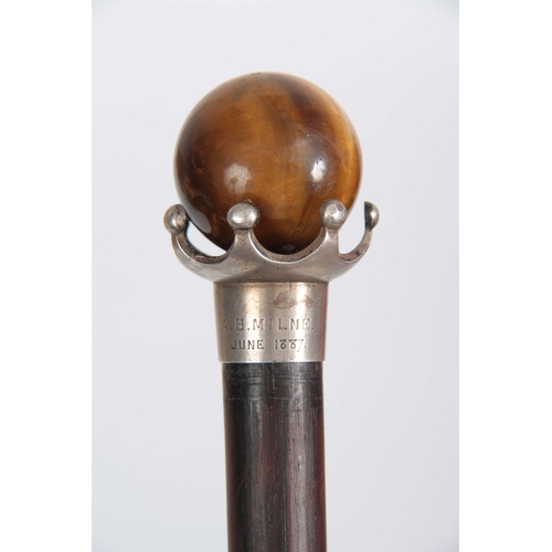 451 - A LATE 19th CENTURY ROSEWOOD WALKING CANE with spherical tigers eye handle on crown style mount, ins... 