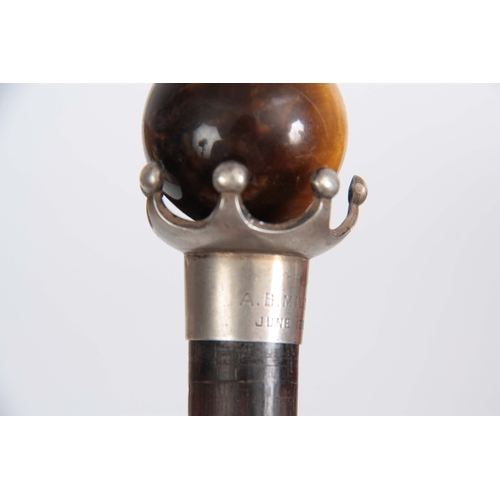 451 - A LATE 19th CENTURY ROSEWOOD WALKING CANE with spherical tigers eye handle on crown style mount, ins... 