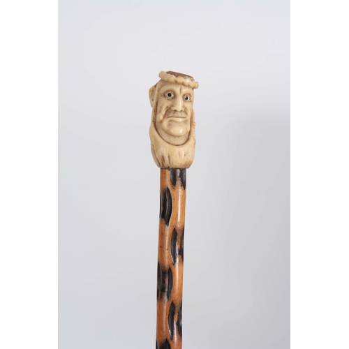 459 - A 19th CENTURY CARVED  STAGHORN HANDLED WALKING CANE modelled as a face with glass eyes, the top wit... 