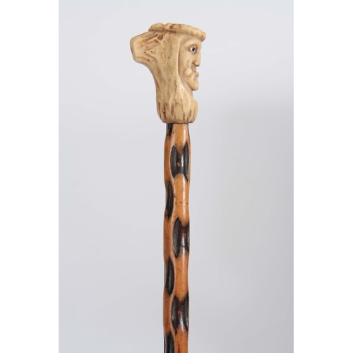 459 - A 19th CENTURY CARVED  STAGHORN HANDLED WALKING CANE modelled as a face with glass eyes, the top wit... 