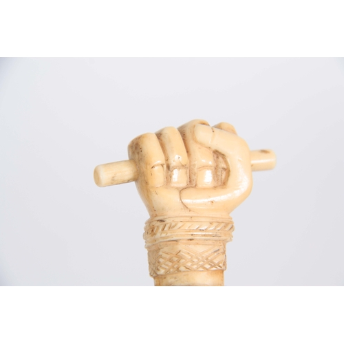 460 - A 19th CENTURY SCRIMSHAW WHALE BONE WALKING CANE having a clenched fist marine ivory handle above in... 