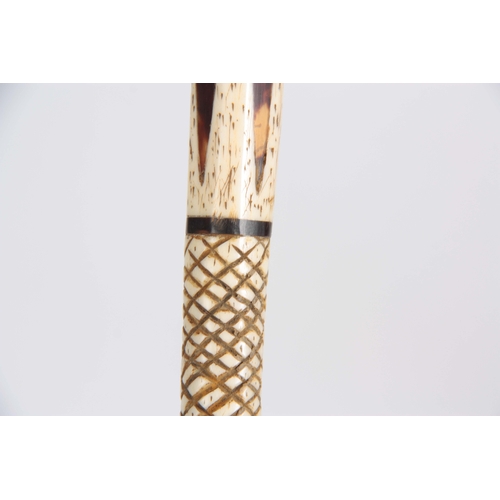 460 - A 19th CENTURY SCRIMSHAW WHALE BONE WALKING CANE having a clenched fist marine ivory handle above in... 