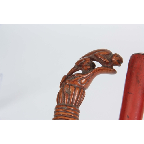 462 - TWO EASTERN WALKING CANES one handle carved with a gecko on a bamboo shaft 89cm long, the other one ... 