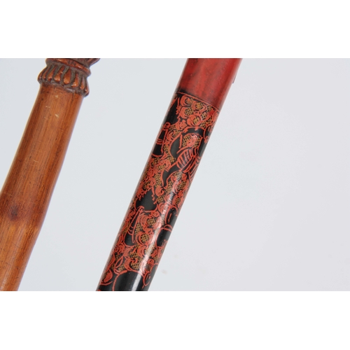 462 - TWO EASTERN WALKING CANES one handle carved with a gecko on a bamboo shaft 89cm long, the other one ... 