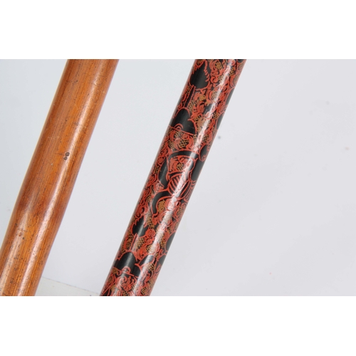 462 - TWO EASTERN WALKING CANES one handle carved with a gecko on a bamboo shaft 89cm long, the other one ... 