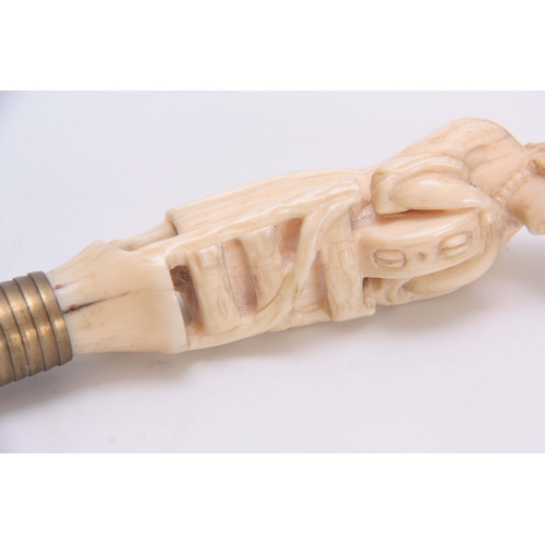 492 - A WELL PATINATED 19TH CENTURY CARVED IVORY FIGURE with brass push on fitting 12cm long