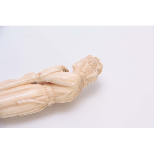 492 - A WELL PATINATED 19TH CENTURY CARVED IVORY FIGURE with brass push on fitting 12cm long