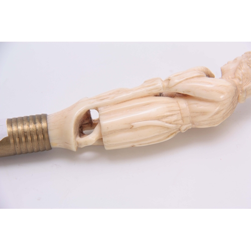 492 - A WELL PATINATED 19TH CENTURY CARVED IVORY FIGURE with brass push on fitting 12cm long