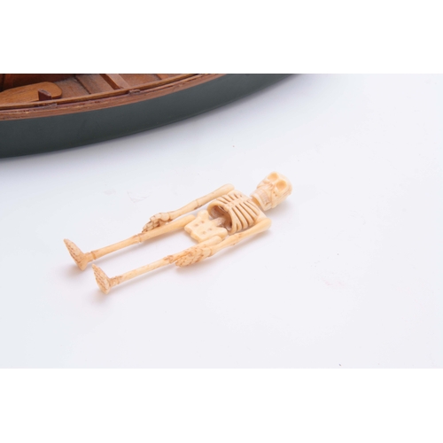 493 - AN UNUSUAL EARLY 20th CENTURY MODEL ROWING BOAT WITH IVORY SKELETON 24cm long