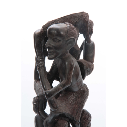 497 - AN AFRICAN CARVED HARDWOOD FIGURAL STATUE 61cm high.