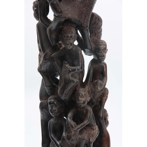 497 - AN AFRICAN CARVED HARDWOOD FIGURAL STATUE 61cm high.