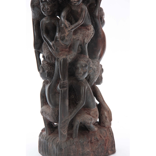 497 - AN AFRICAN CARVED HARDWOOD FIGURAL STATUE 61cm high.