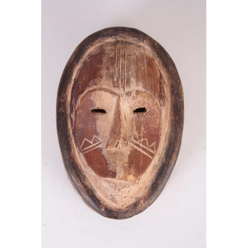 498 - AN ANTIQUE AFRICAN CARVED WOOD CIRCUMCISION MASK with white and black painted decoration 27.5cm high... 