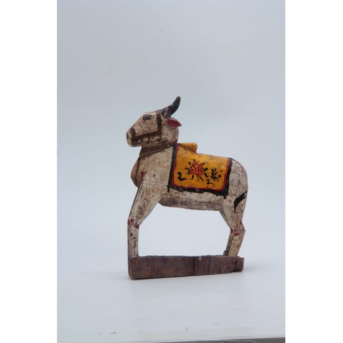 502 - A CARVED AND PAINTED HINDU NANDI COW 31cm high 20cm wide