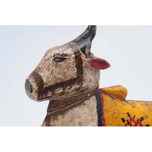 502 - A CARVED AND PAINTED HINDU NANDI COW 31cm high 20cm wide