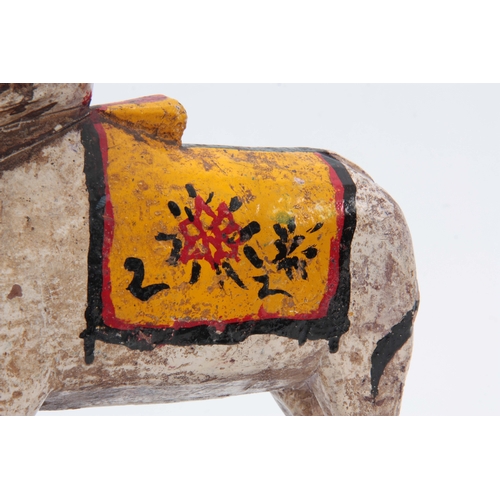 502 - A CARVED AND PAINTED HINDU NANDI COW 31cm high 20cm wide